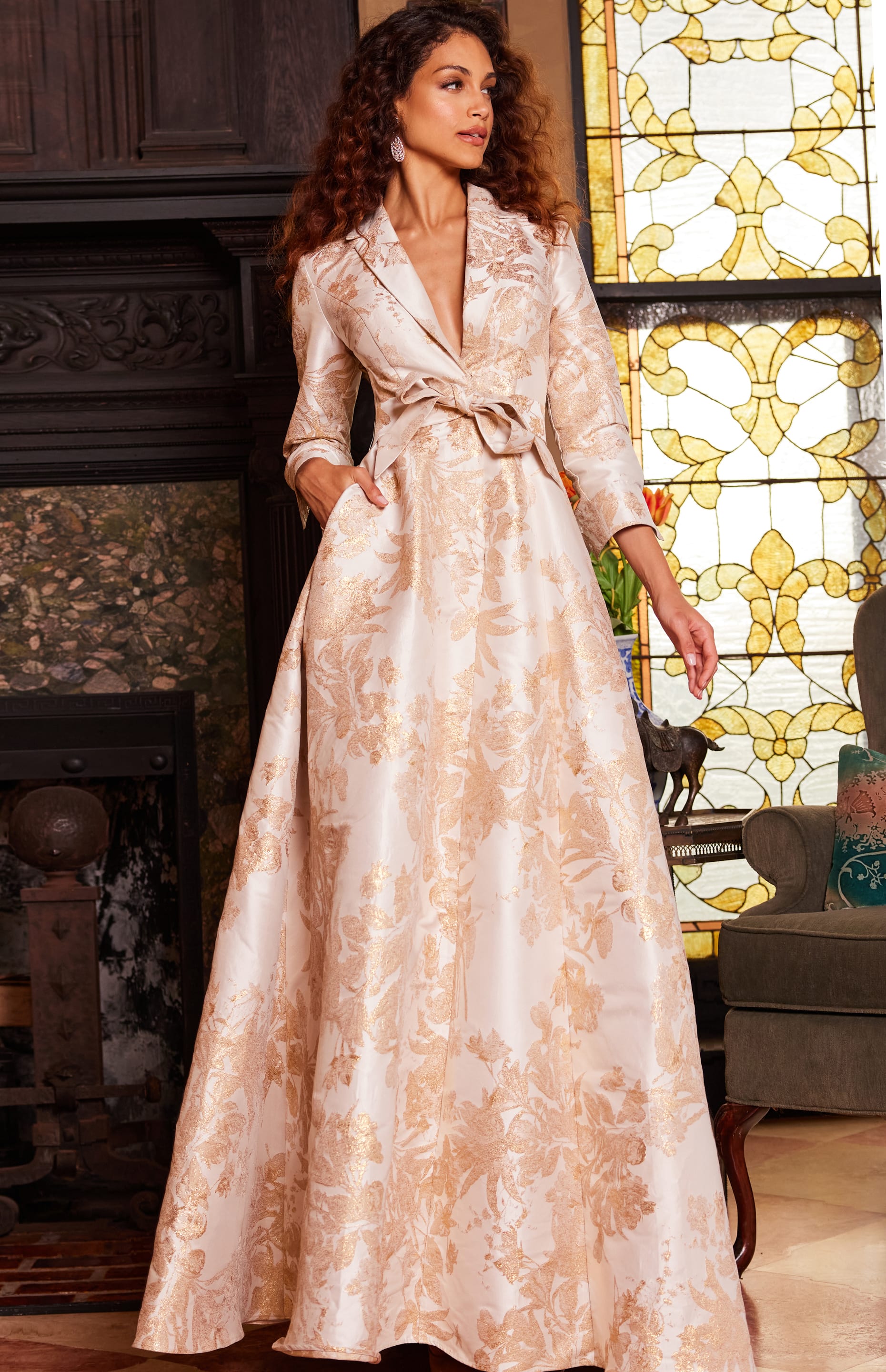 Model showcasing Jovani 23178 gold floral dress with pockets