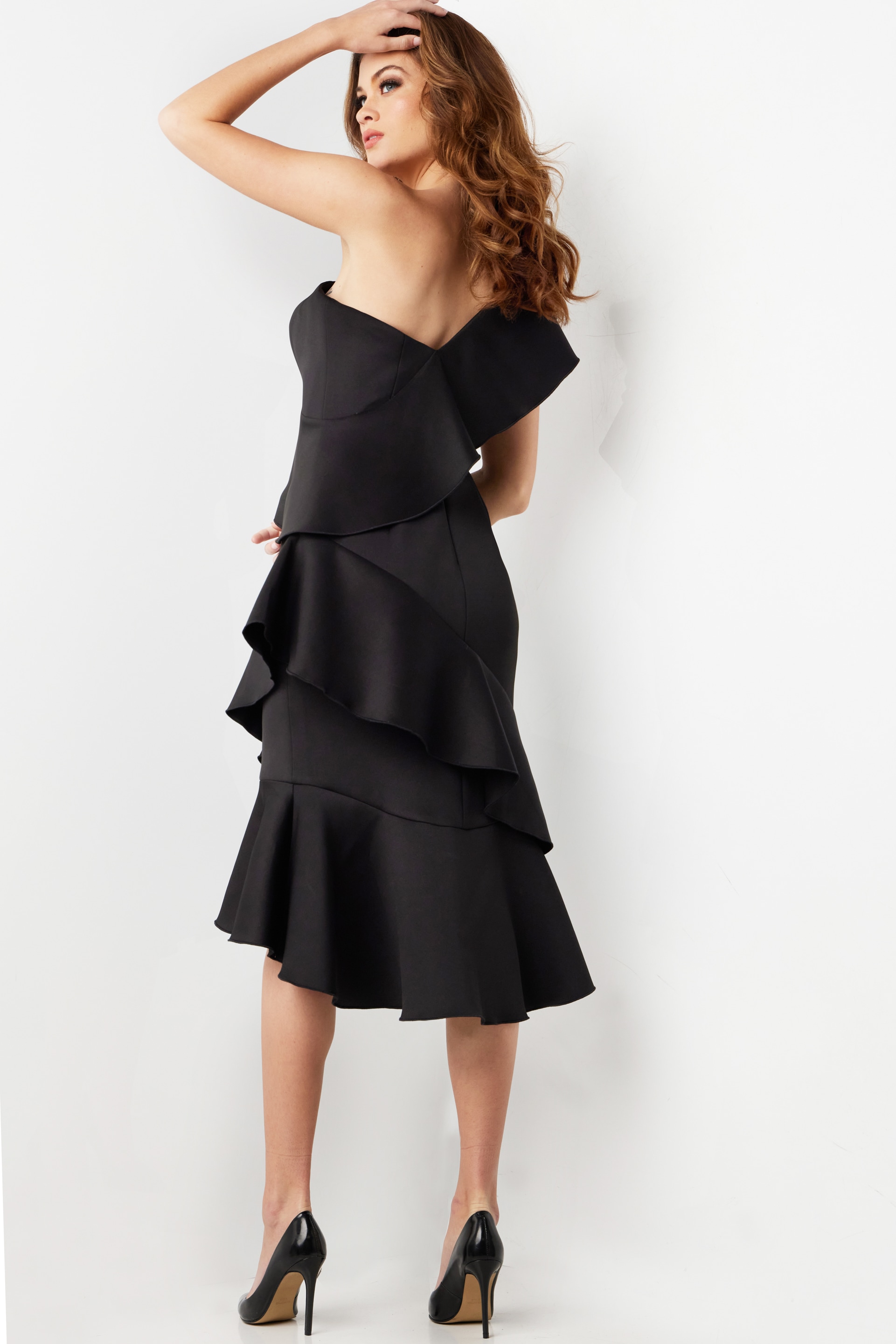 Back view of model in Jovani 25971 black dress highlighting one-shoulder design.