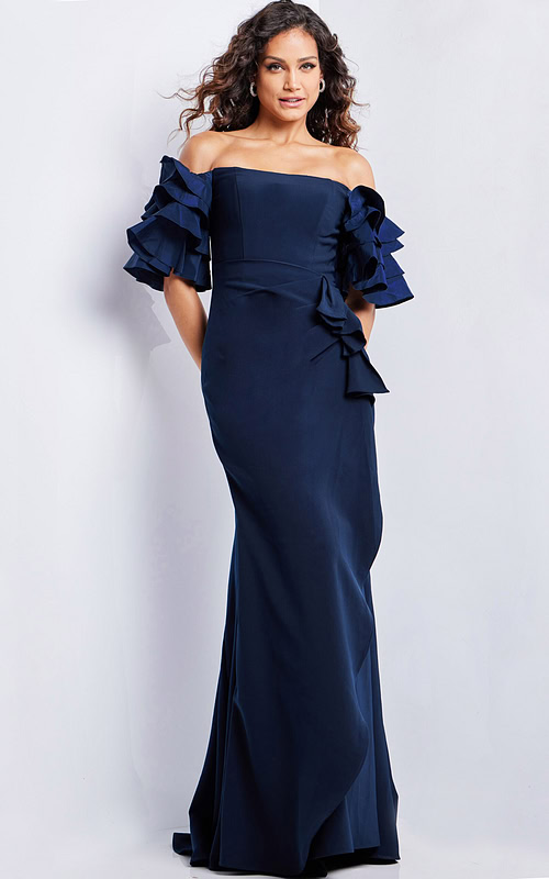Model wearing Jovani 37674 navy dress with off-the-shoulder ruffle sleeves in mermaid silhouette.