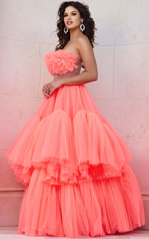 Model wearing Jovani 38299 orange gown with floral ruffles and embellished waist, front full-length view.