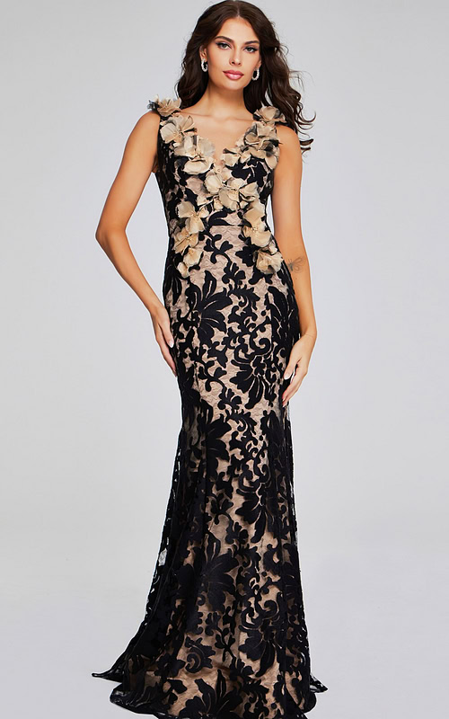 Model wearing Jovani 38497 black lace gown with floral appliqués, front view.