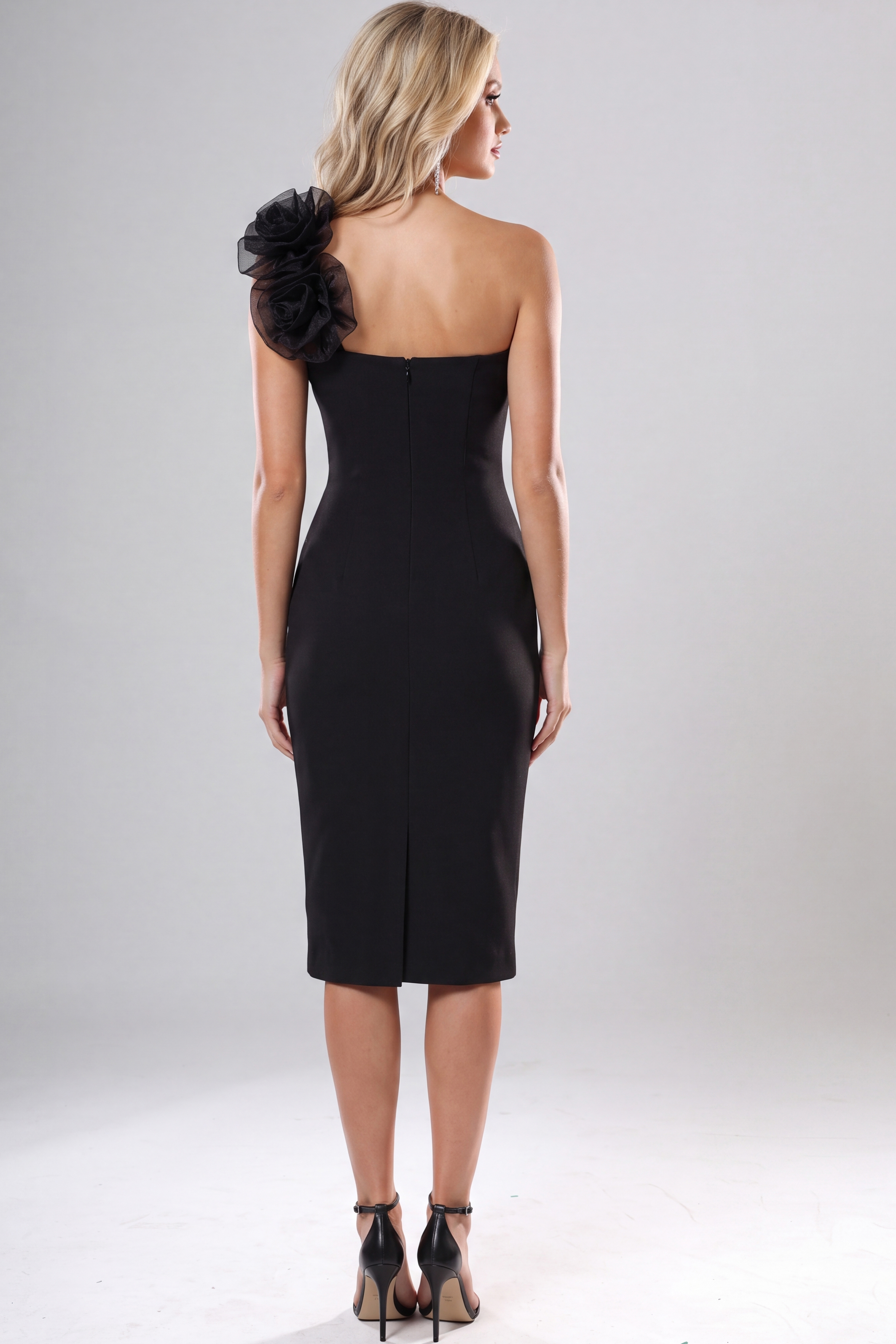 Black one shoulder midi dress with oversized floral appliqué detail and fitted silhouette