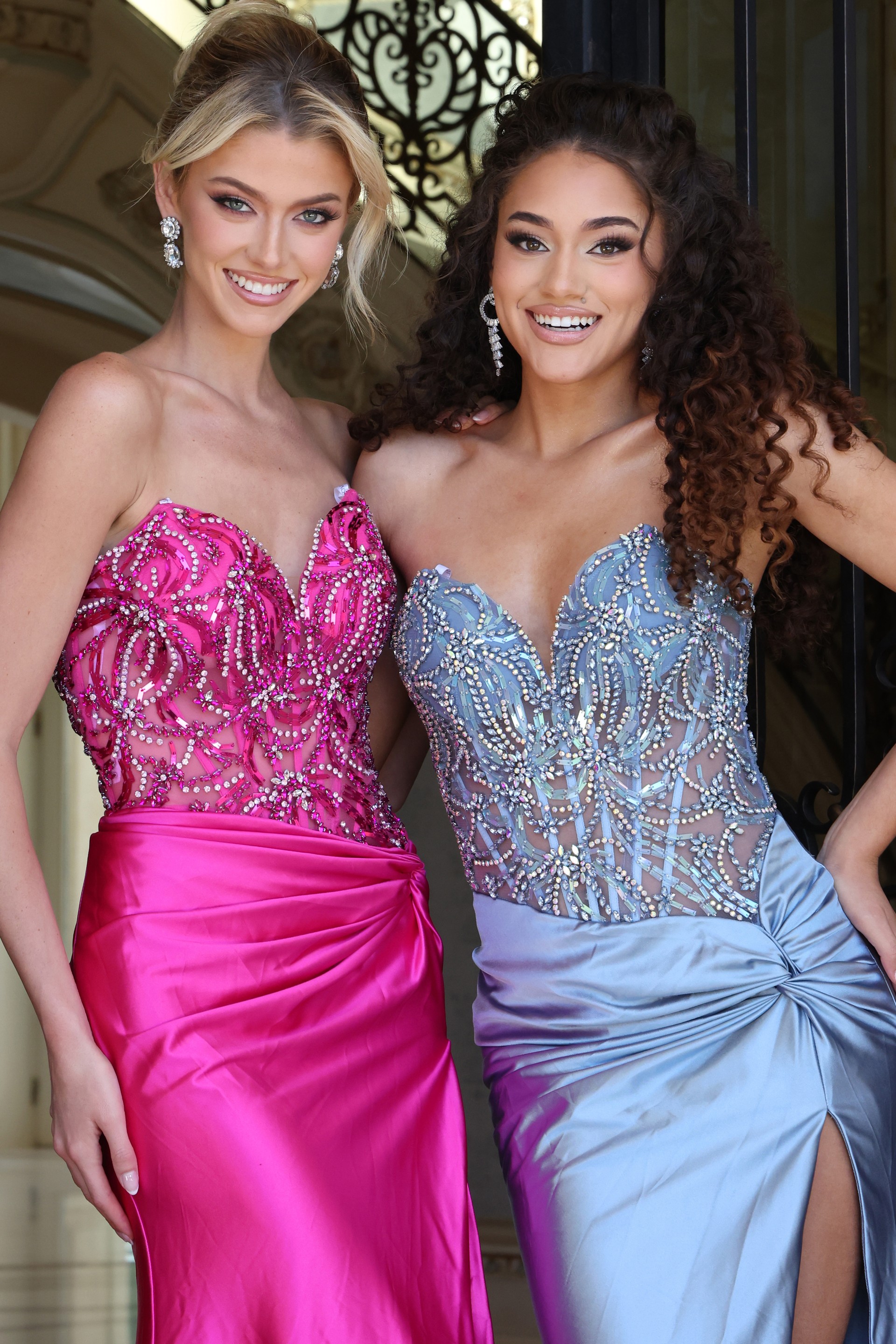 beaded corset dress with high slit - two girls front, blonde updo dark curly hair smiling