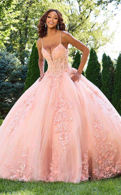 Model wearing Jovani 43431 blush gown with floral appliqués, front view.