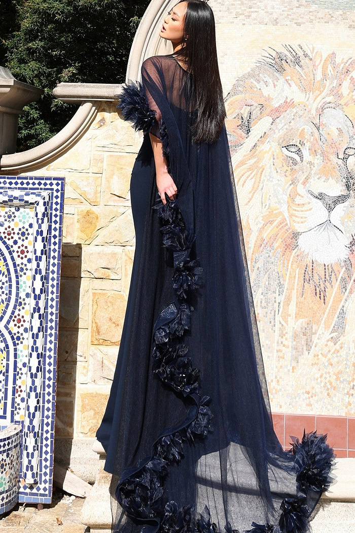 Couture-inspired navy dress with sheer overlay and floral accents