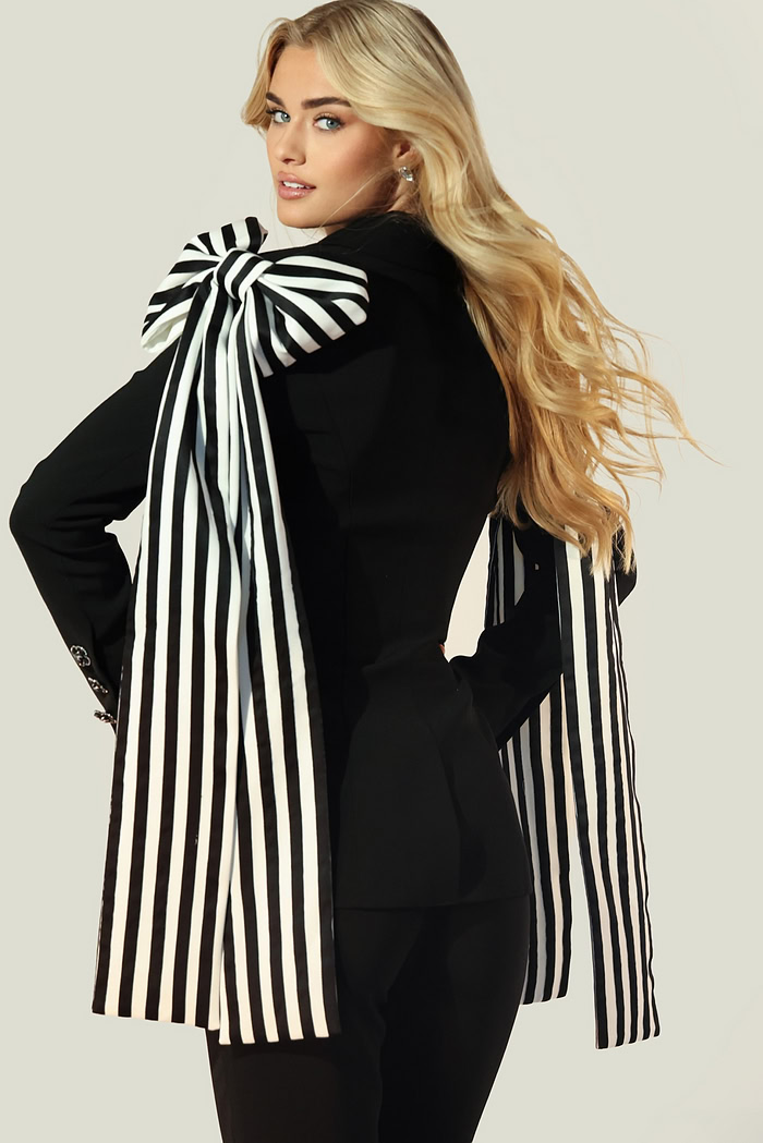 Fashion-forward black blazer and pants with dramatic bow shoulders