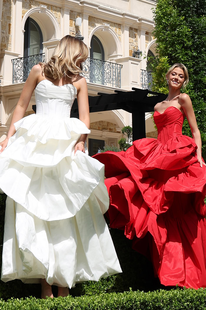 strapless layered ruffle ball gown - two girls front, white red dresses holding skirts
