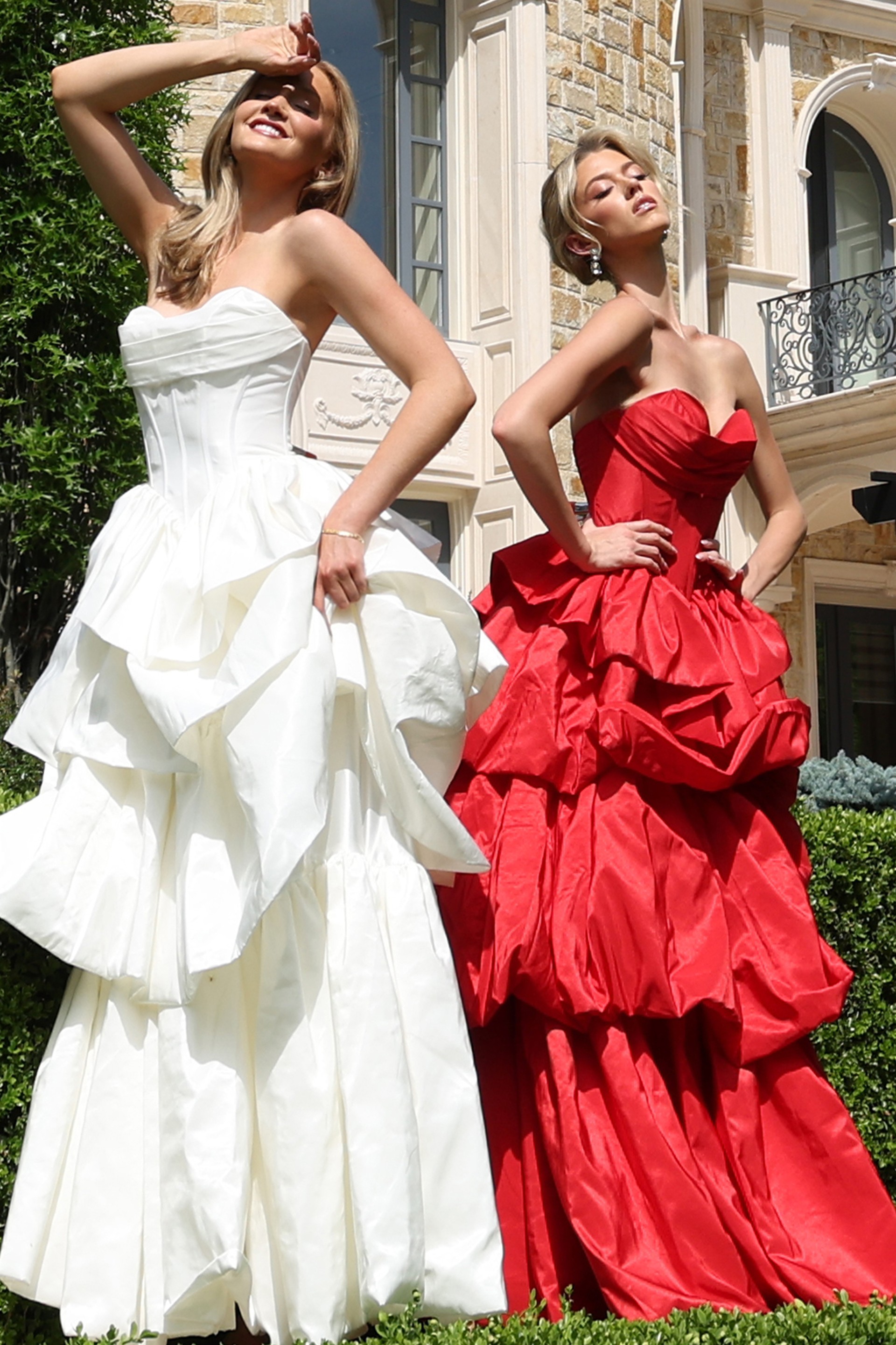 strapless layered ruffle ball gown - two girls front, contrasting vibrant gowns, expressive poses