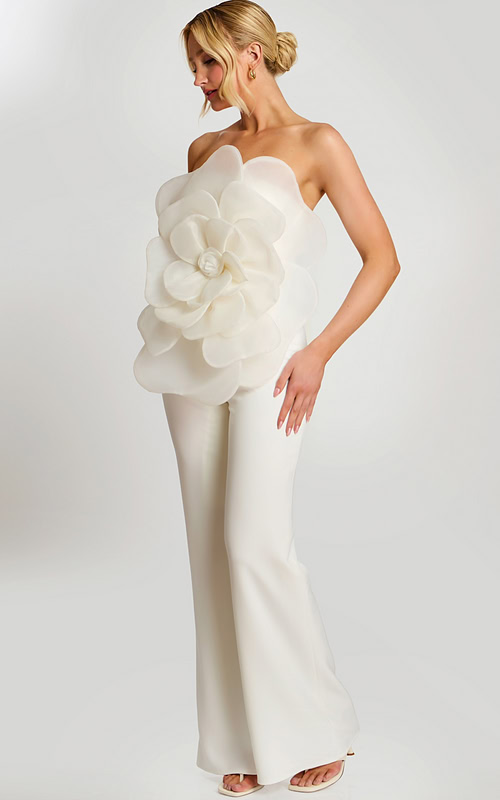 Woman wearing off-white strapless jumpsuit with large floral applique