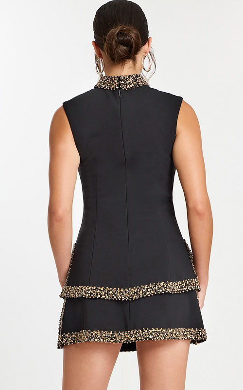 Back view of black mini dress with tiered skirt and beaded trim