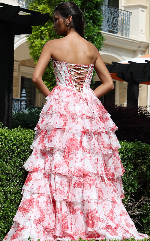 whitered strapless floral ball gown with ruffled skirt - back view, model hands on hips looking left