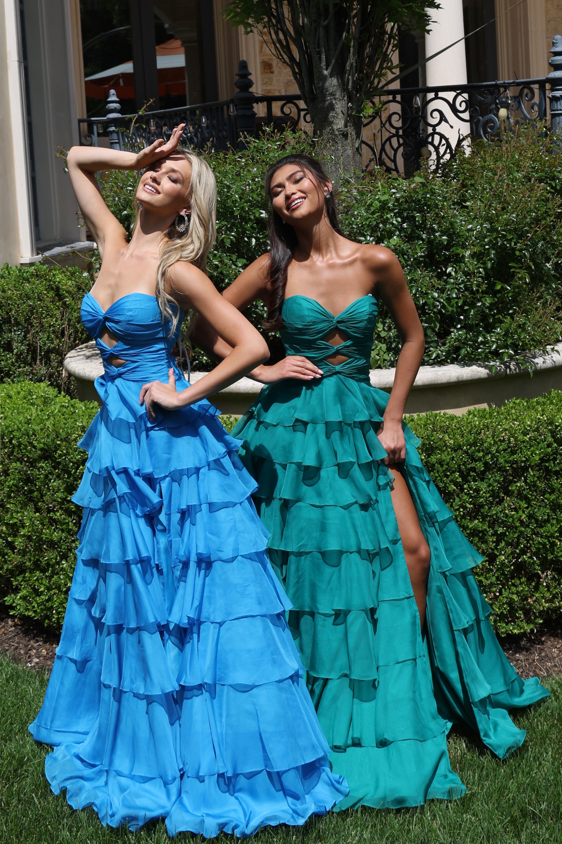 ruffled strapless tiered prom dress - two girls front, blonde hand shielding eyes, brunette showing leg