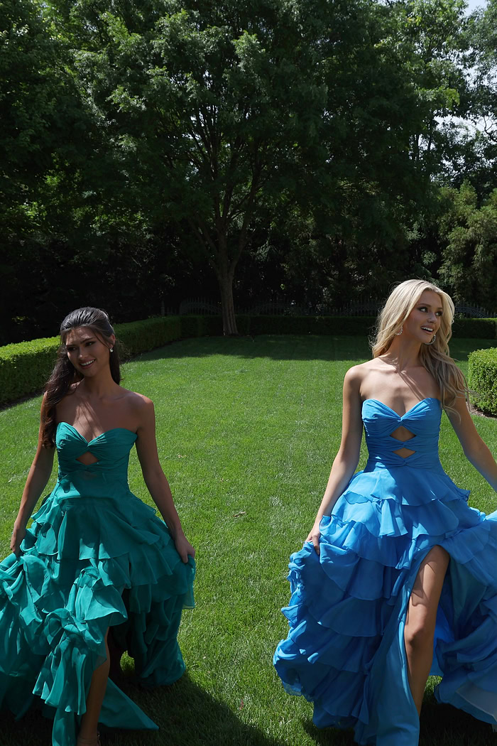 ruffled strapless tiered prom dress - two girls front, blonde dark hair walking grass
