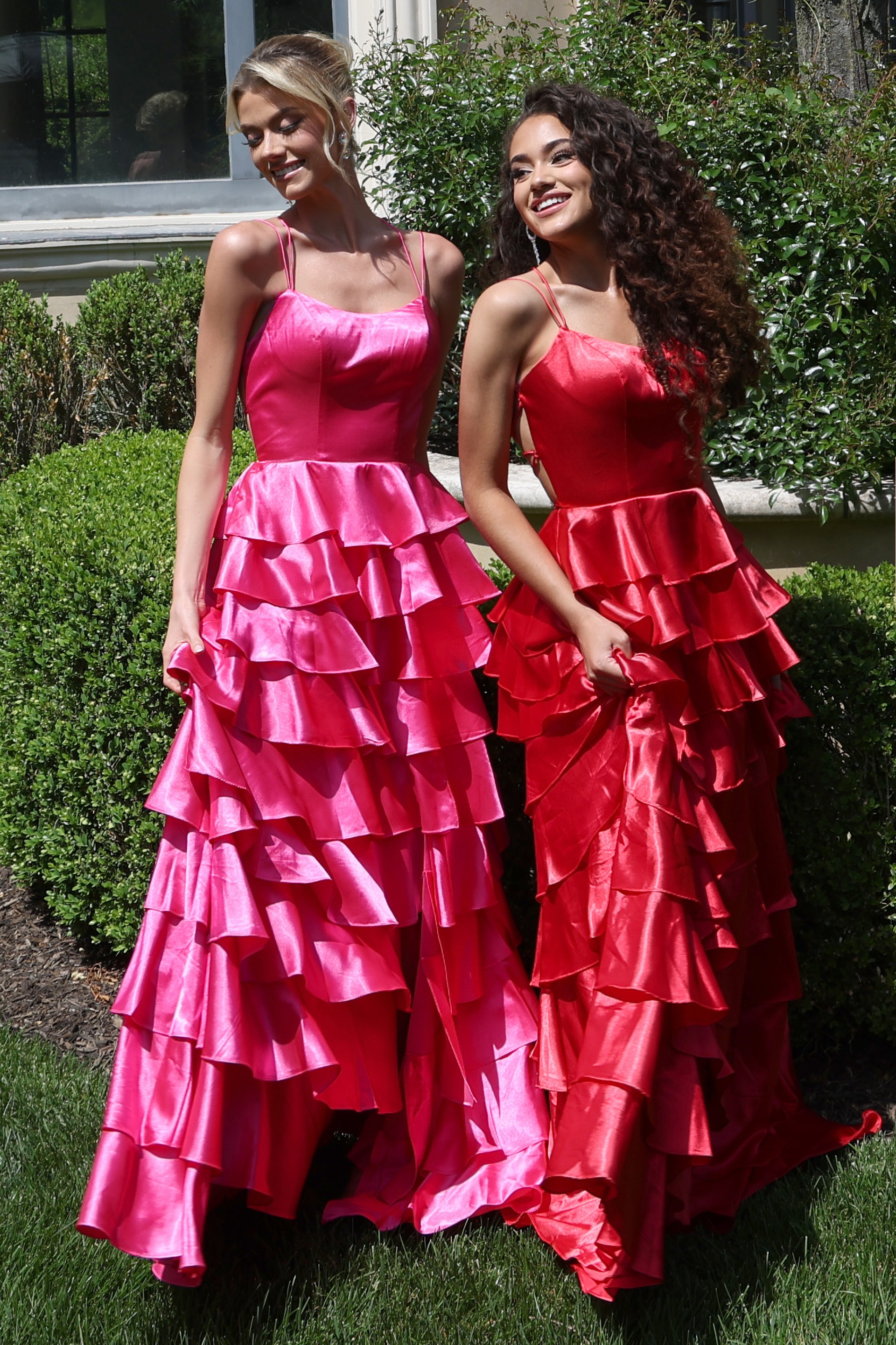tiered satin dress with spaghetti straps - two girls front, blonde updo curly hair smiling
