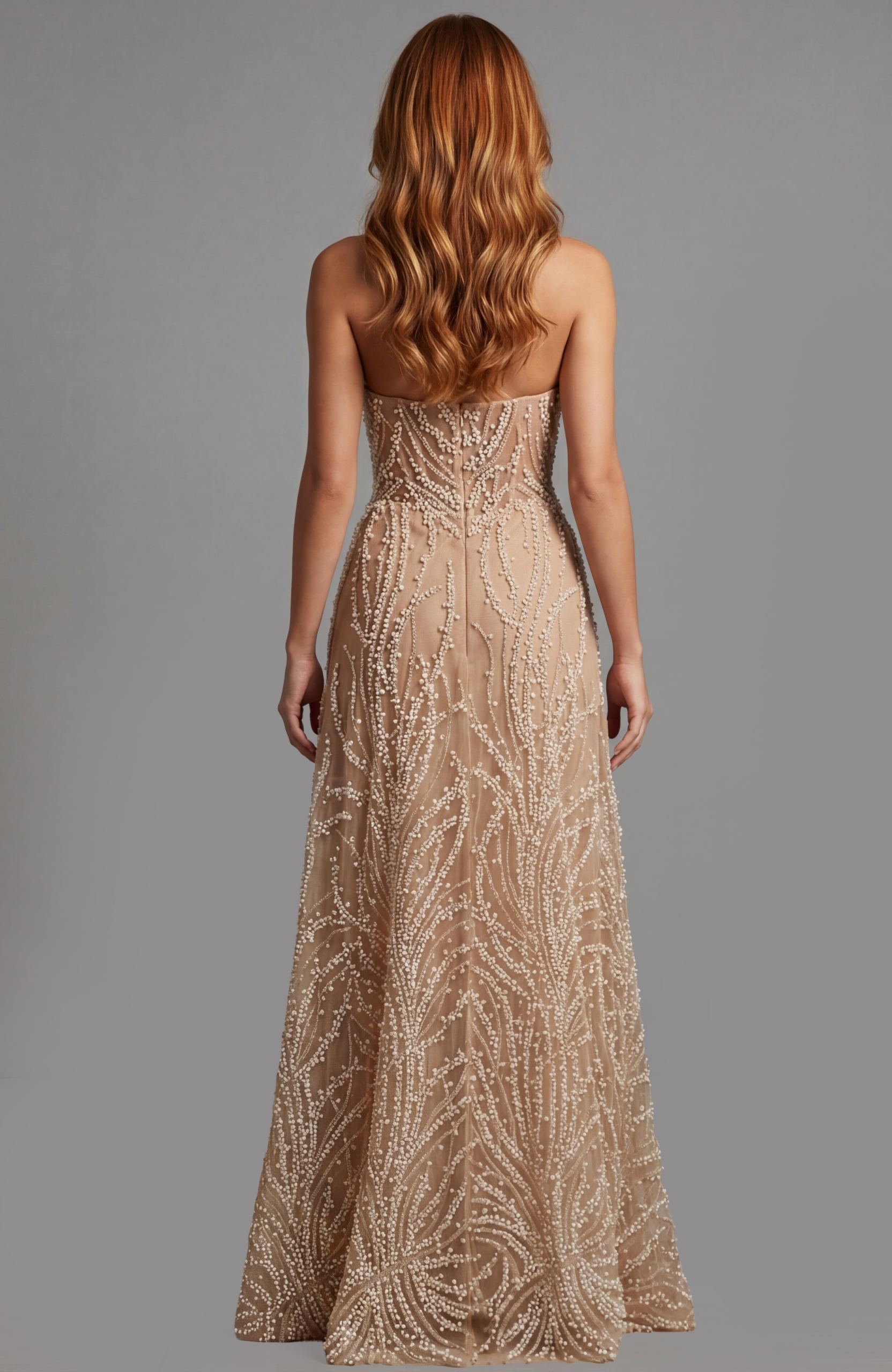 Back view of strapless gown with sheer fabric and intricate beadwork