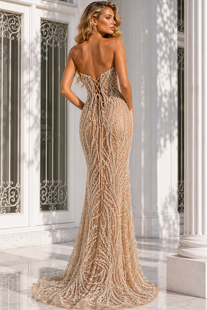 Back view of a champagne beaded evening gown featuring a lace-up corset back, sheer illusion fabric, and intricate pearl-inspired embellishments.