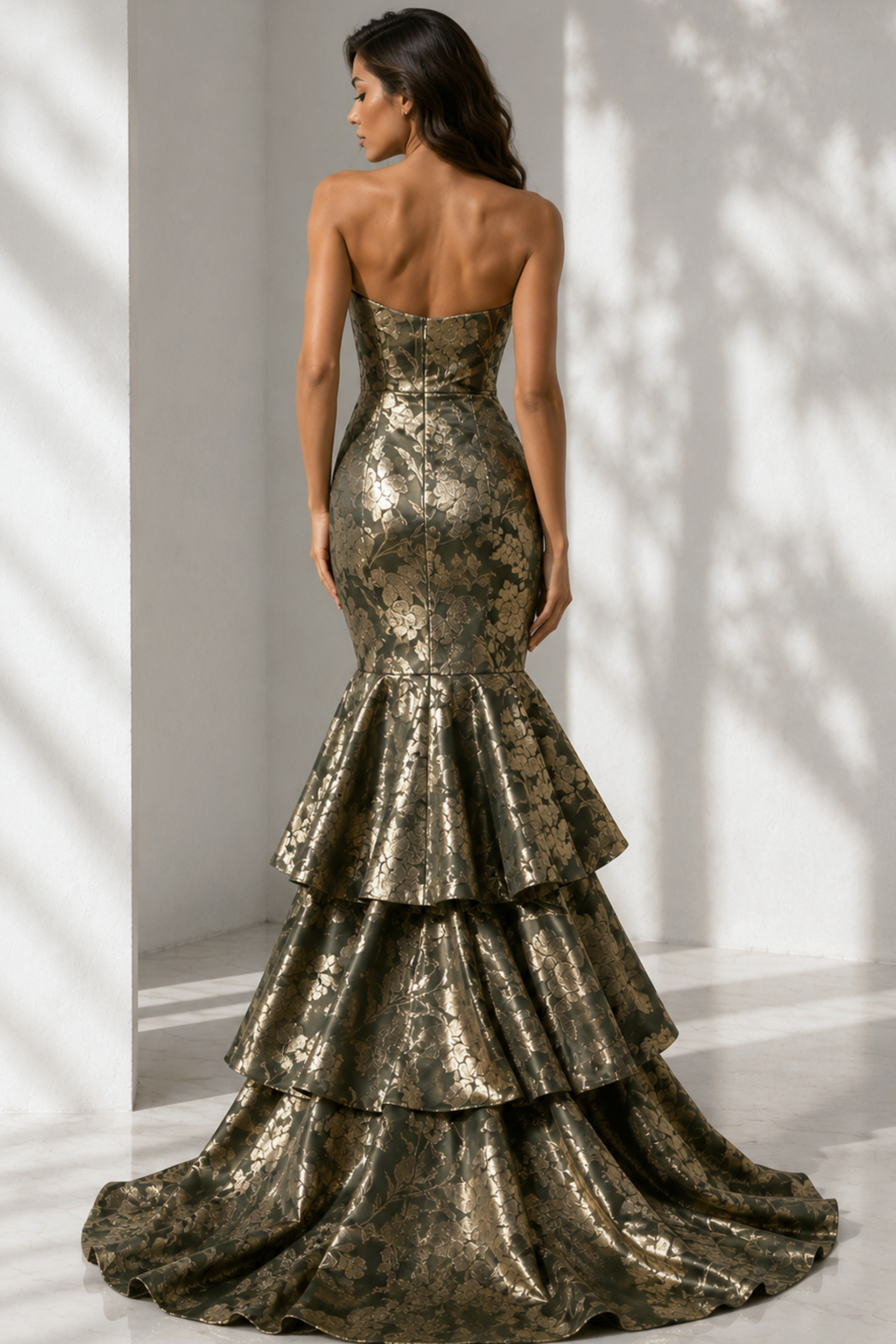 Dark olive and gold floral brocade mermaid gown with tiered ruffle skirt and elegant train, shown from the back.