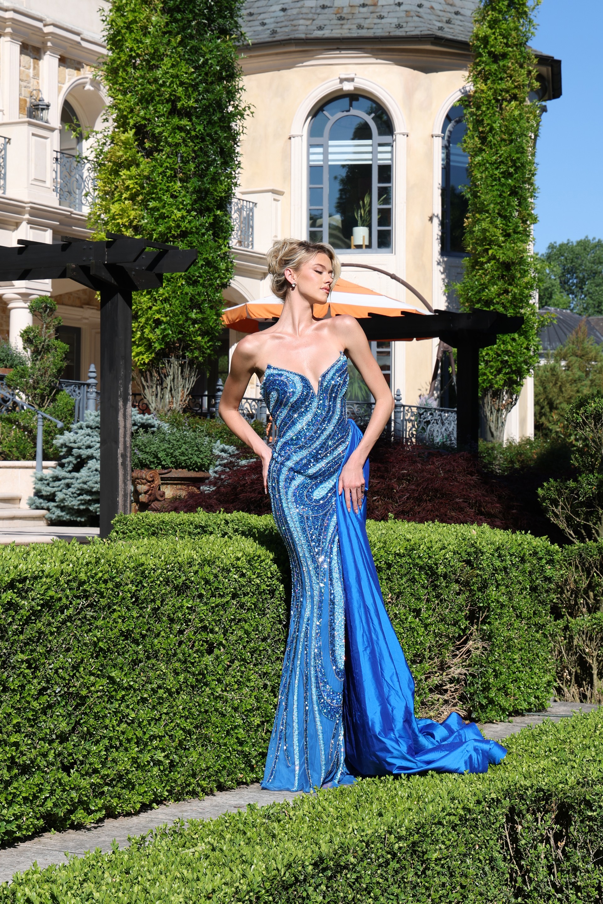 strapless sequin gown with overskirt and high slit