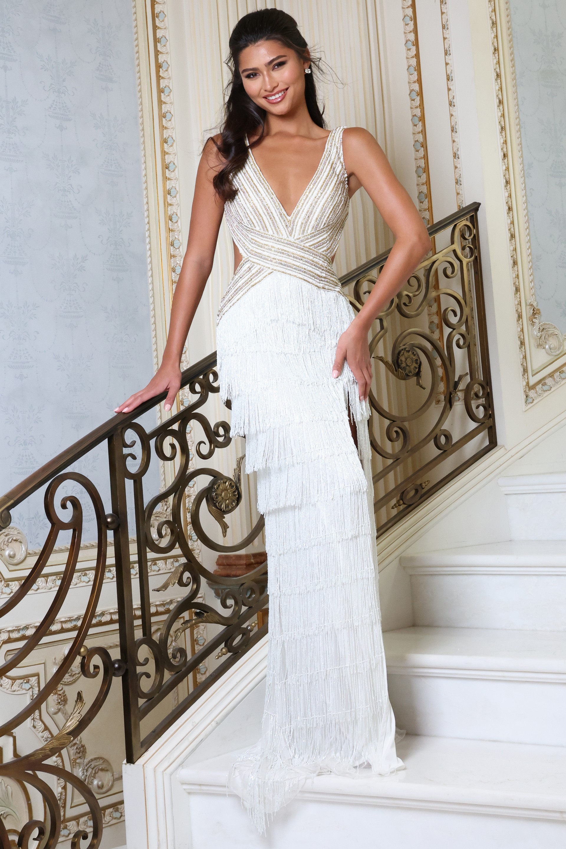 white v neck beaded fringe dress with high slit - front full body, smiling, hand on railing, tiered fringe