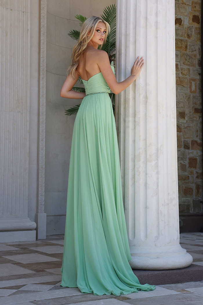 mint strapless coral chiffon a-line gown - three quarter view, leaning column looking over shoulder
