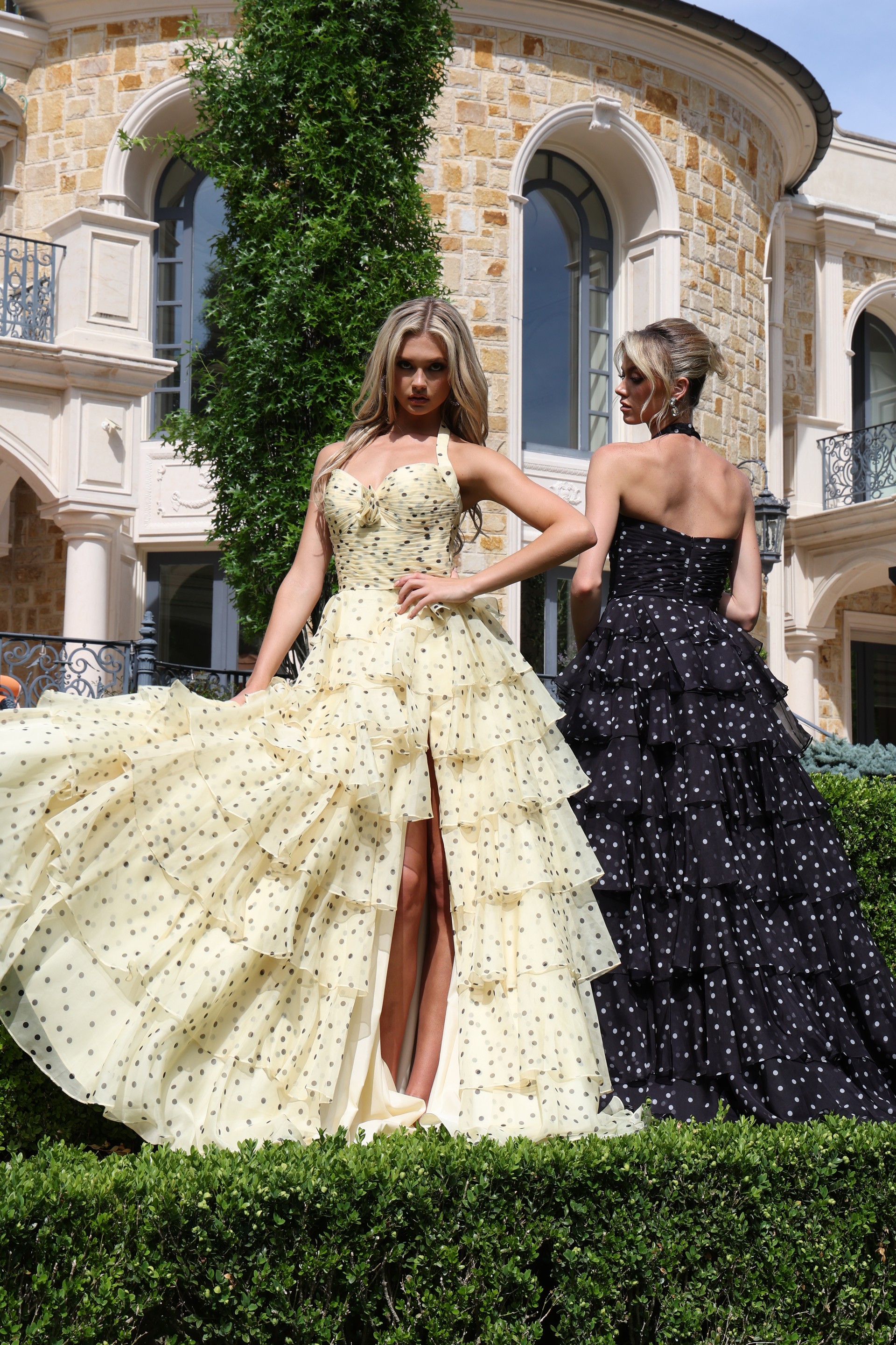 halter polka dot tiered dress with bow bodice - two girls front, blonde slit fanned, black angled