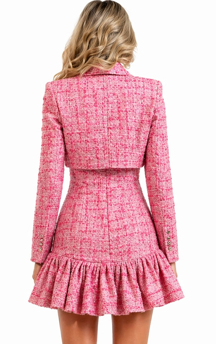 Back view of a coordinated pink tweed set showing the tailored fit of the cropped jacket and the ruffled silhouette of the matching mini dress.