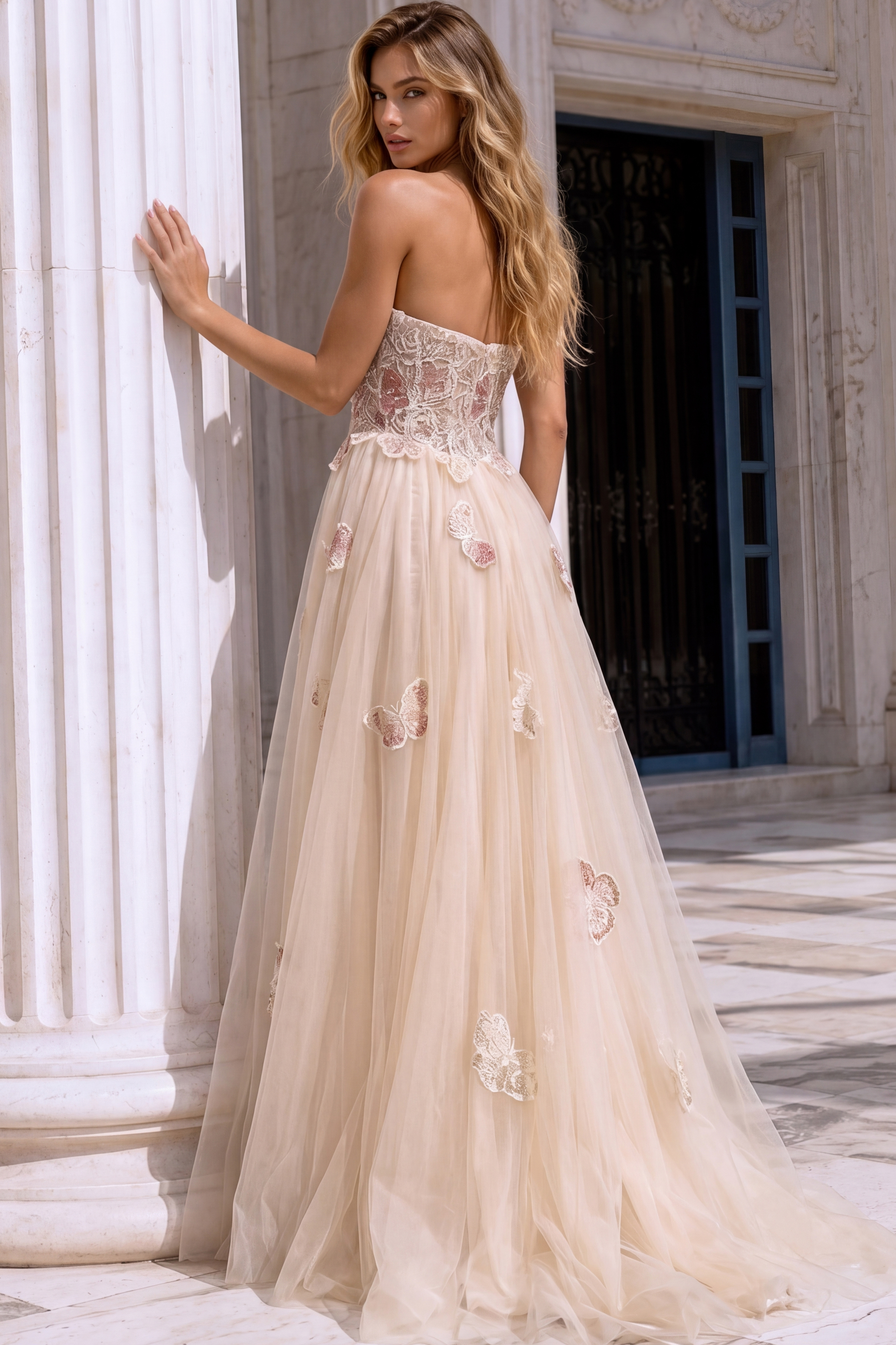 Back view of a blush champagne formal dress with a lace corset bodice