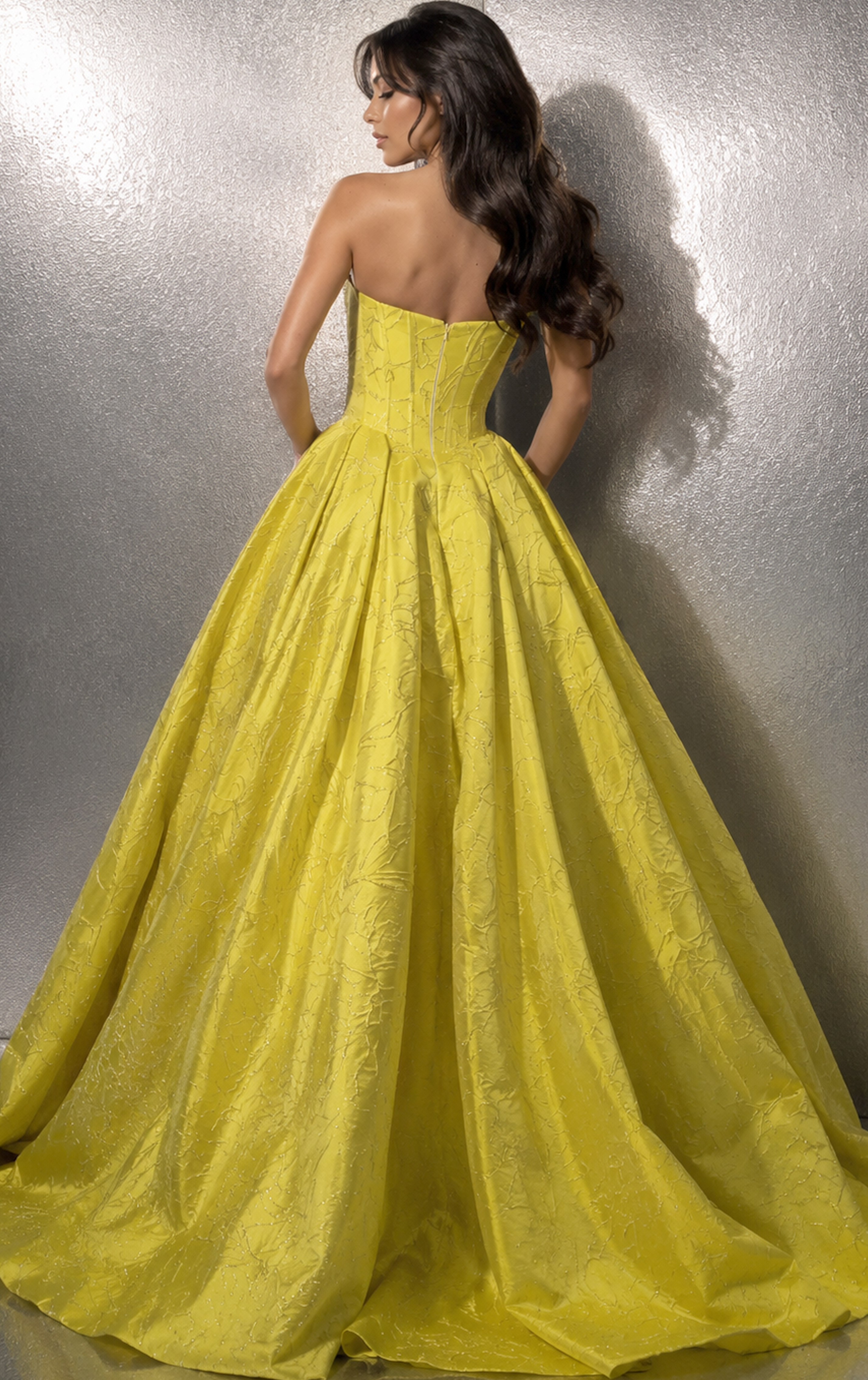 back view of yellow jacquard strapless ball gown