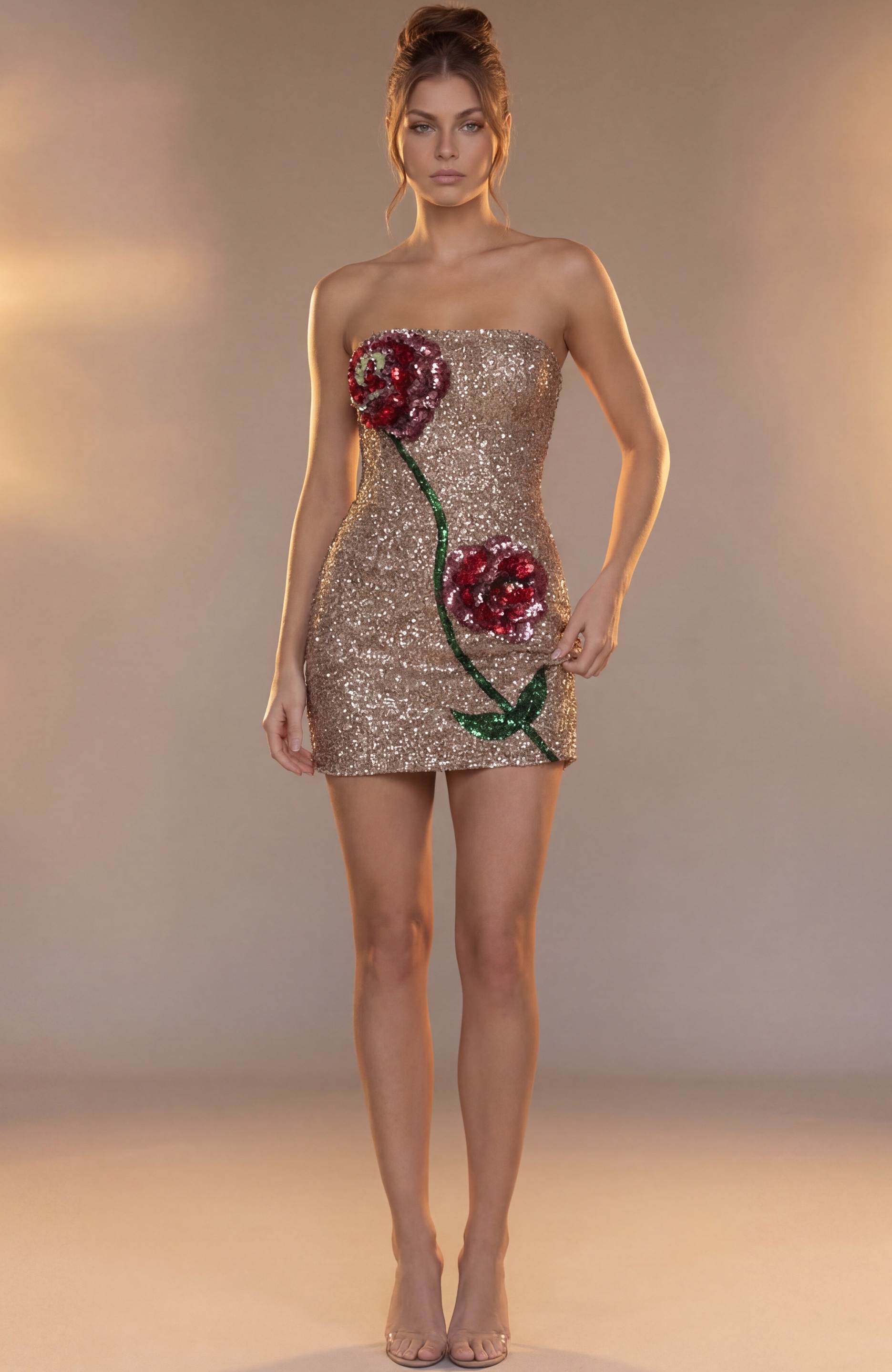 dense gold sequin embroidery and the contrasting textures of the red floral appliqué.