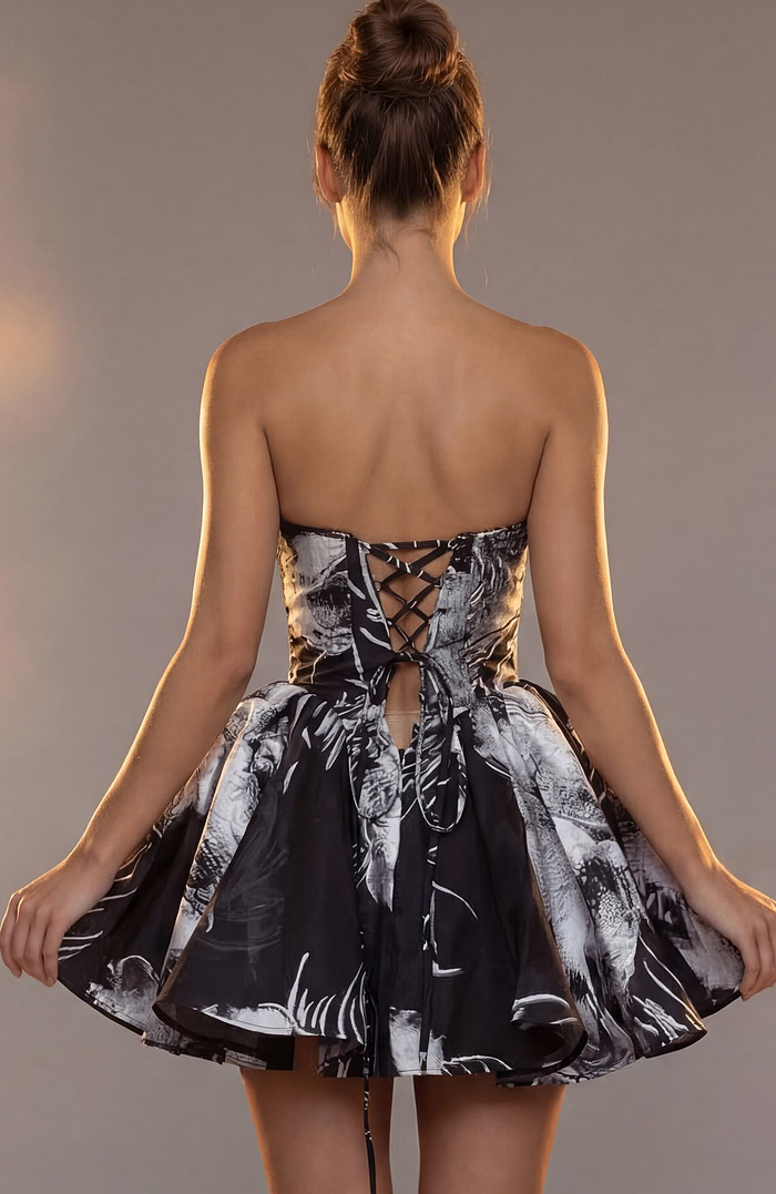 Back view of a black and white printed party dress featuring a corset-style lace-up closure.
