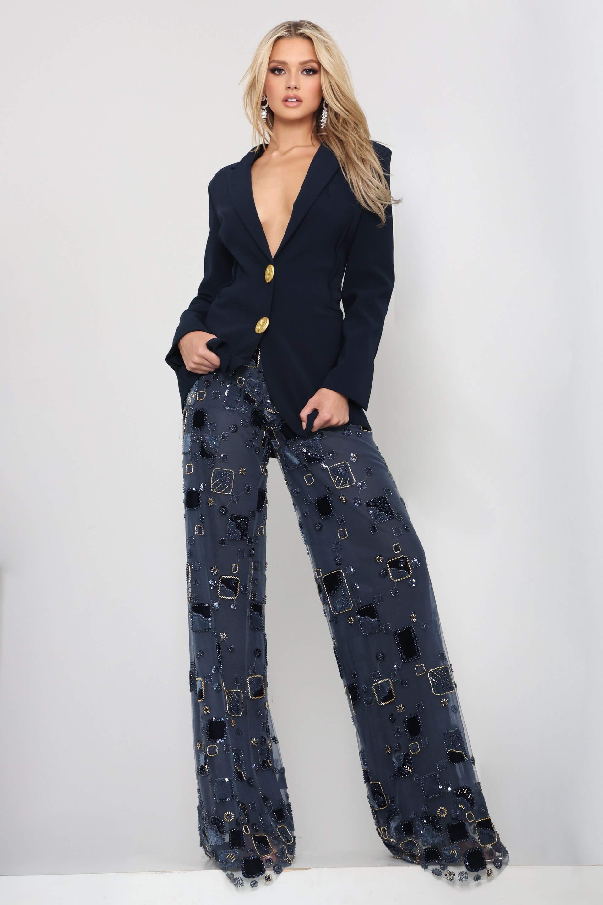 Jovani style 52096 navy beaded blazer jumpsuit with plunging neckline, gold buttons and sheer embellished wide leg pants, front view