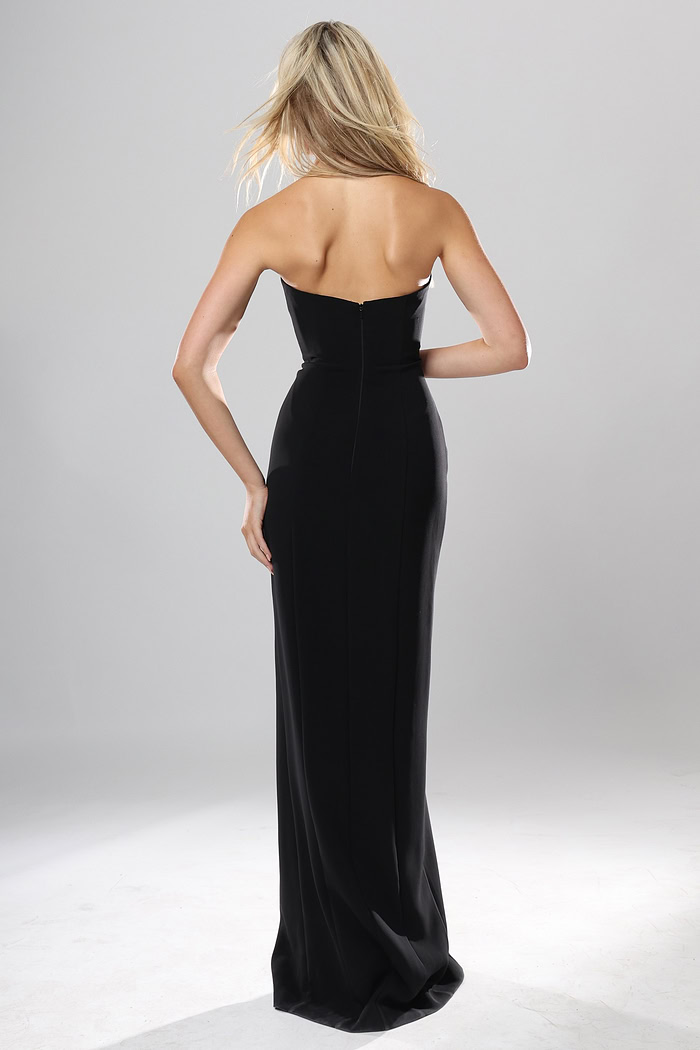 back view of black crepe strapless fitted long gown with rhinestone rose applique and high slit, Jovani style 53108