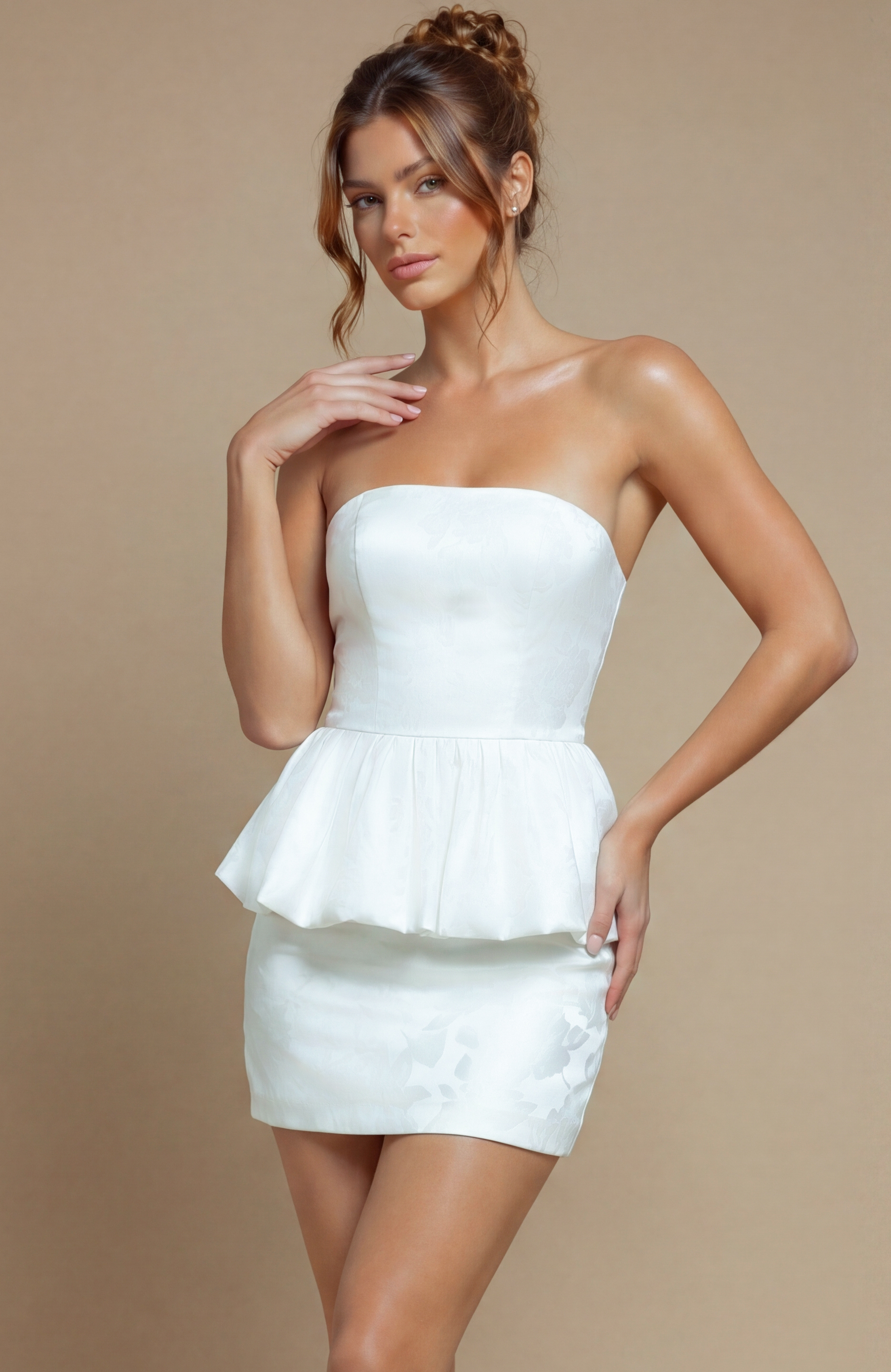 White evening dress featuring a reinforced bodice for a tailored fit and a sculptural, ruffled peplum hemline.