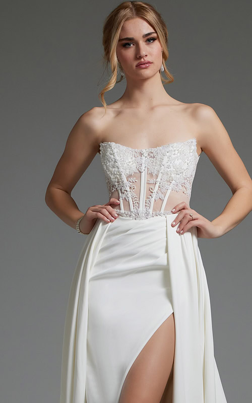 Model showcasing Jovani JB37128 ivory dress's lace bodice and high slit.