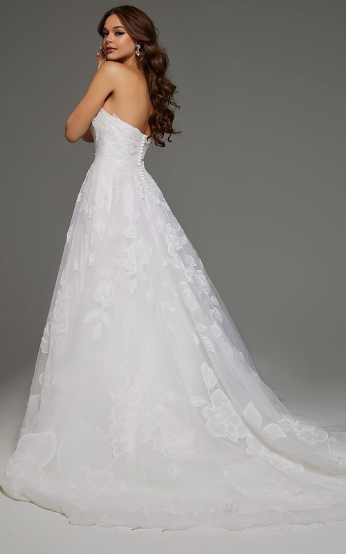 Back view of model in Jovani JB42324 showing button details and floral applique on ivory fabric.