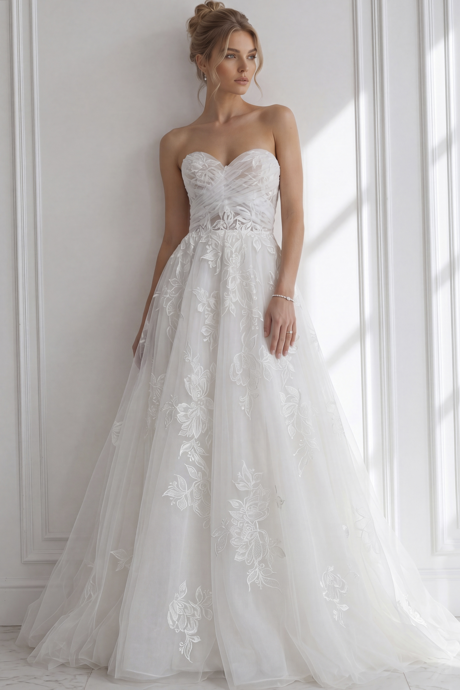Romantic strapless gown crafted in sheer ivory tulle, featuring floral embroidery across the bodice and skirt, a softly cinched waist.