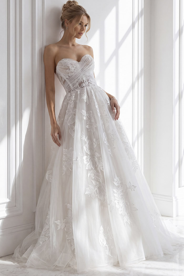 Classic white ballgown wedding dress with a fitted, strapless bodice and subtle ruched detailing,