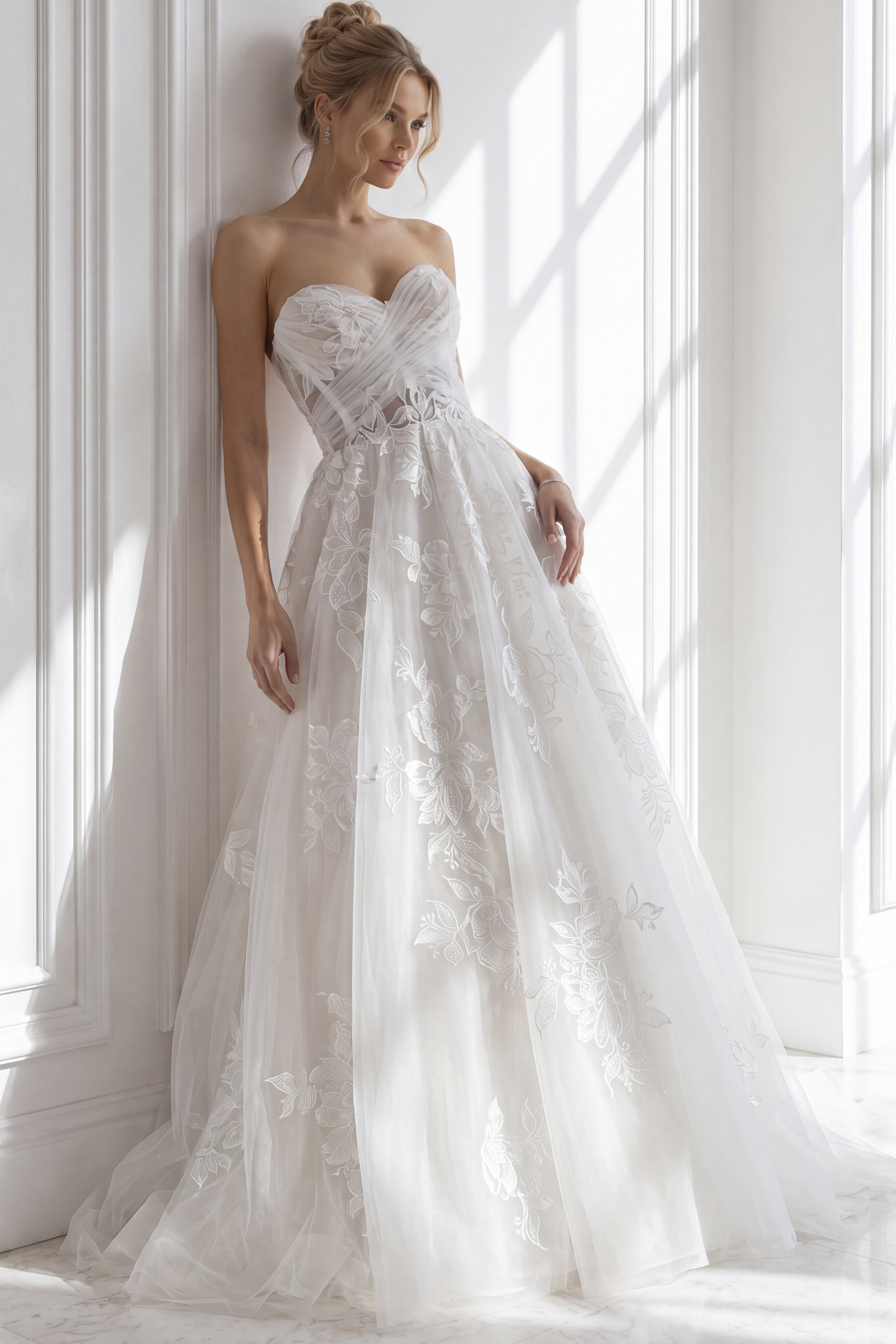 Classic white ballgown wedding dress with a fitted, strapless bodice and subtle ruched detailing,