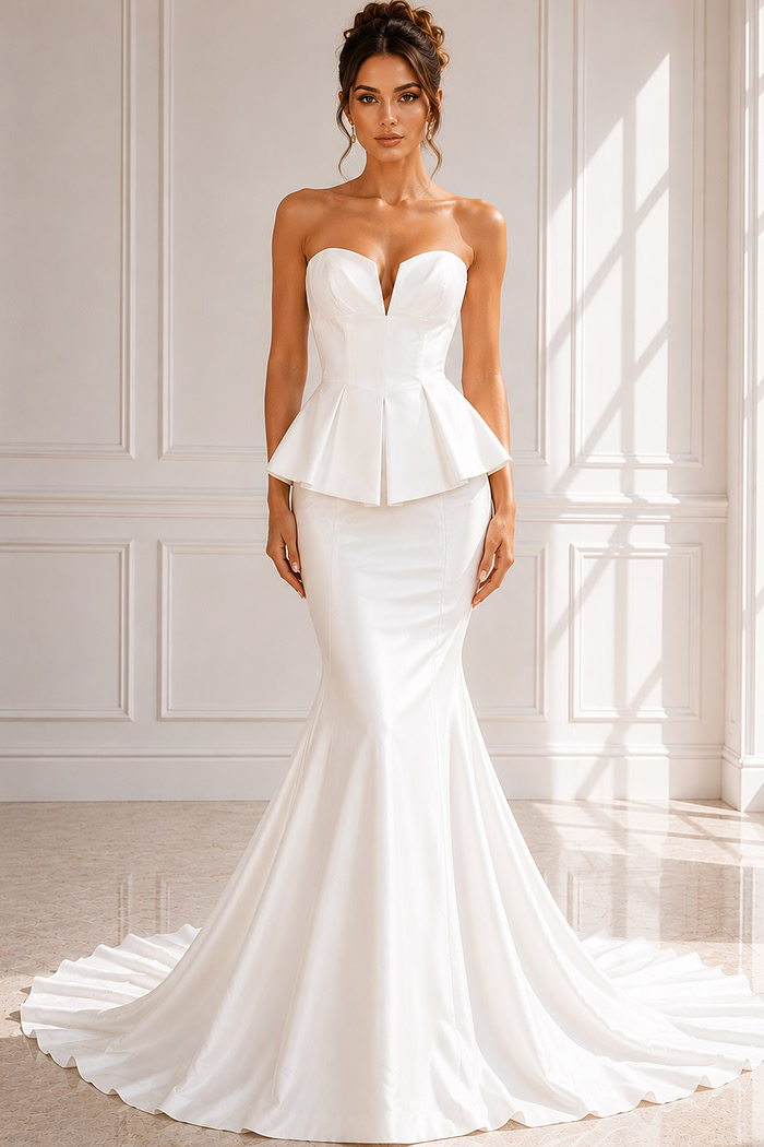 Elegant fit-and-flare wedding dress with clean lines, peplum detail, and chapel train.
