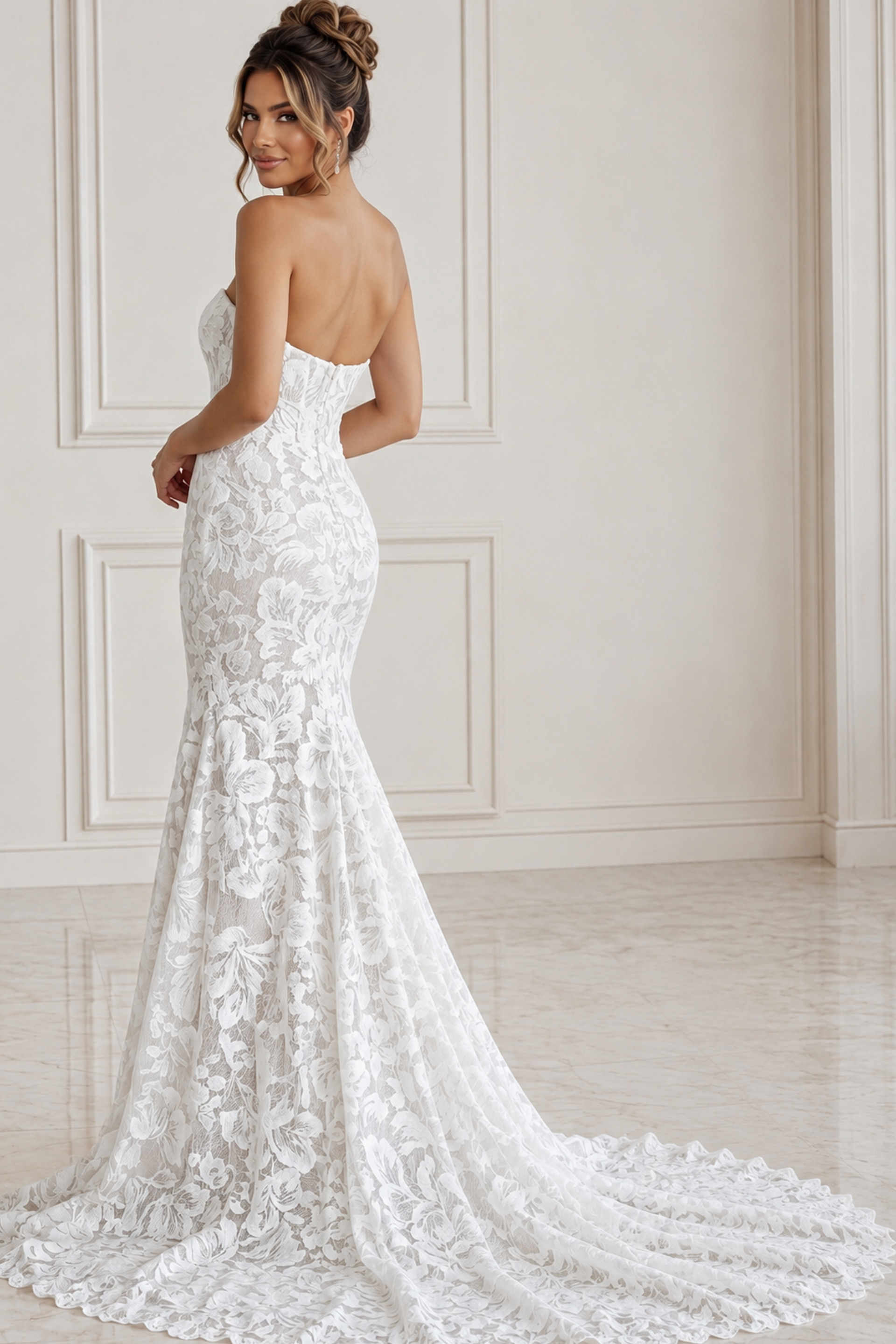 Back view of fitted lace bridal gown with long veil and elegant train