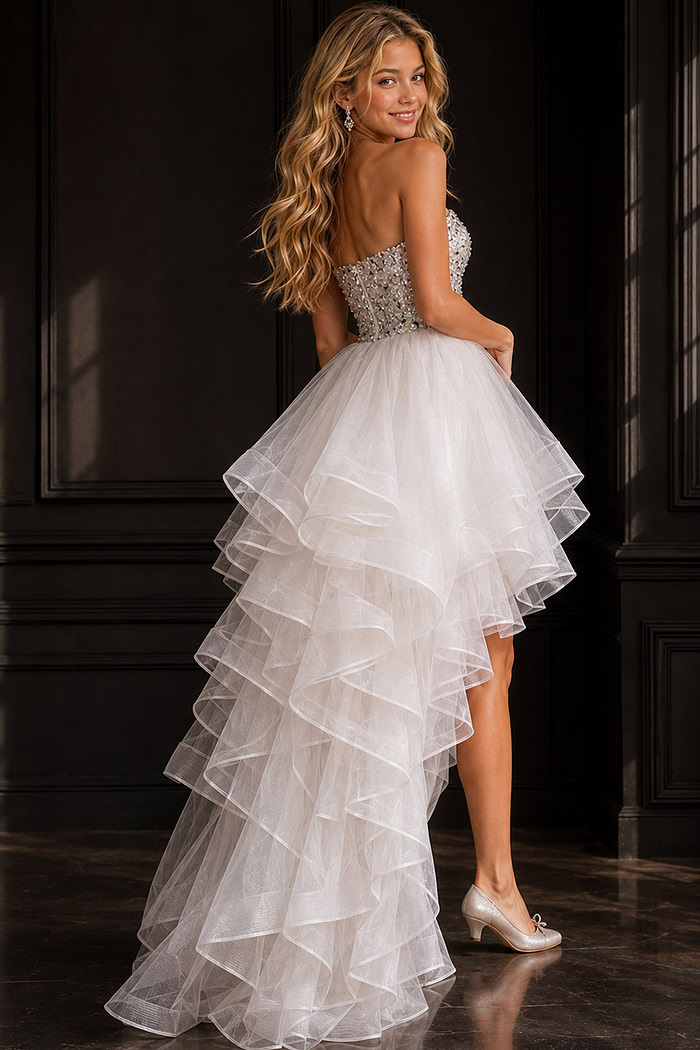 back view of white high low dress with crystal beaded bodice and ruffled tulle skirt
