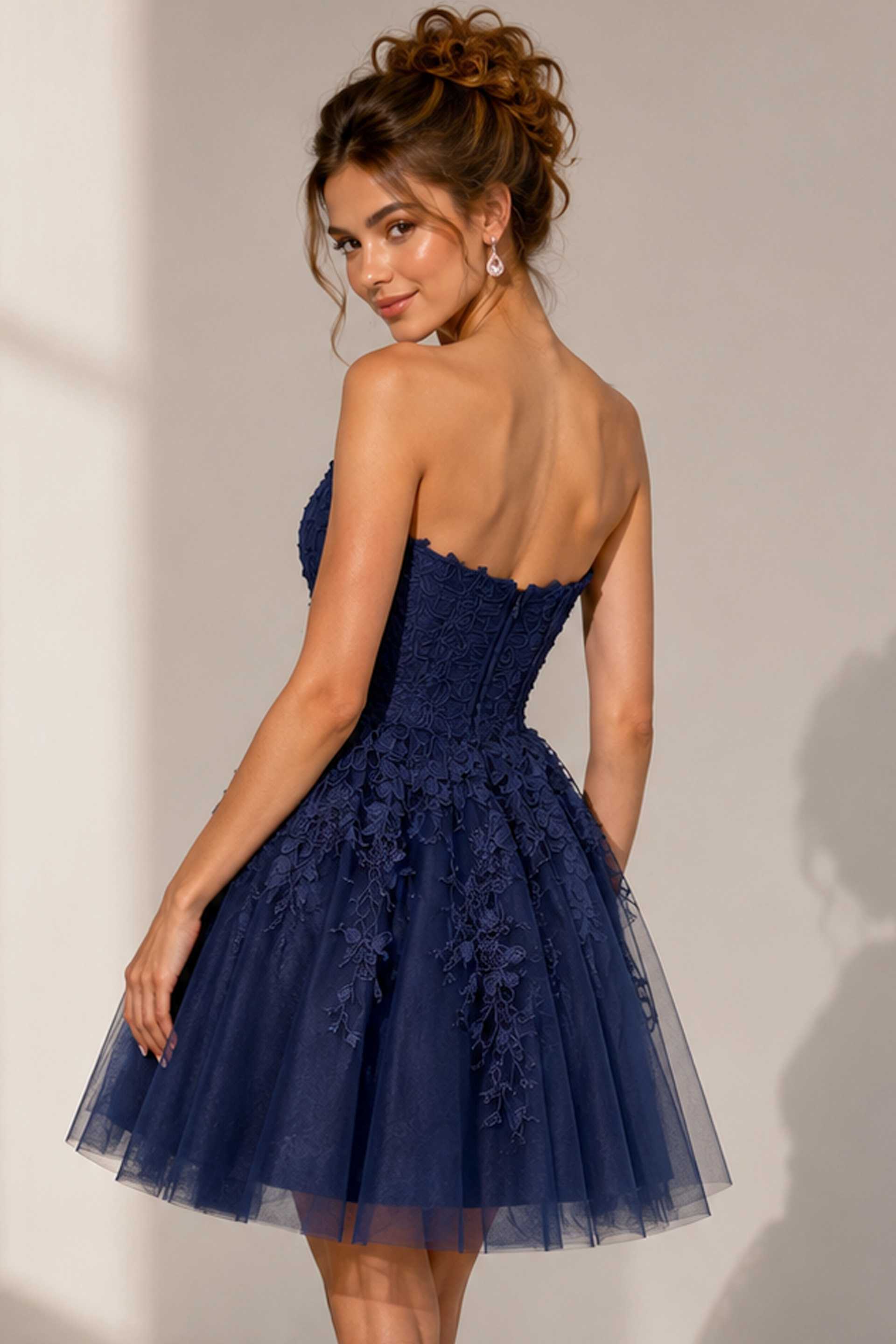 back view of navy floral lace fit and flare dress with corset back