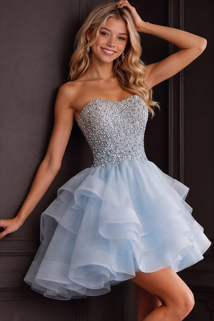 Sparkling light blue dress with fitted sequined top and voluminous ruffles.