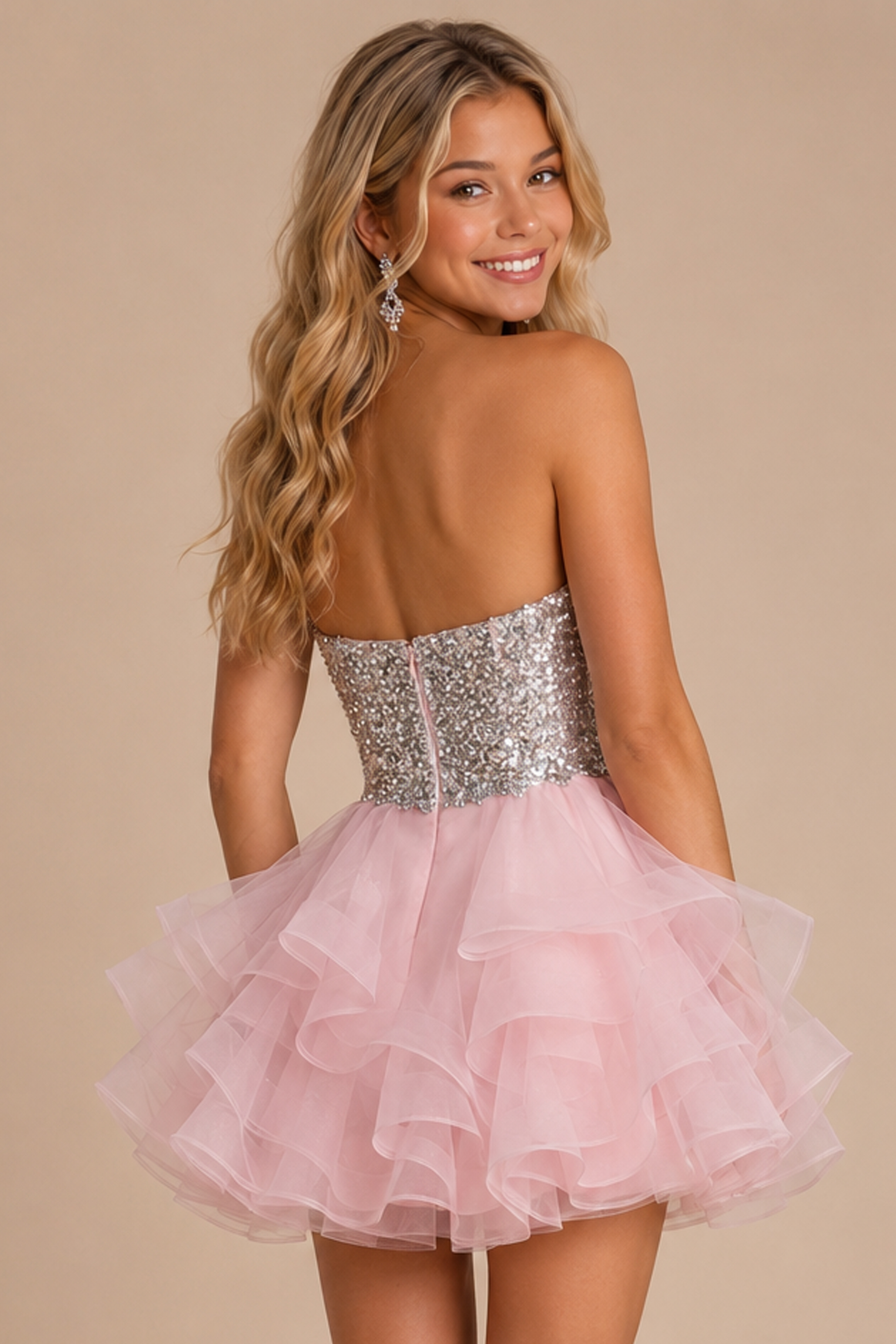back view of pink dress with sequin bodice and ruffle organza skirt