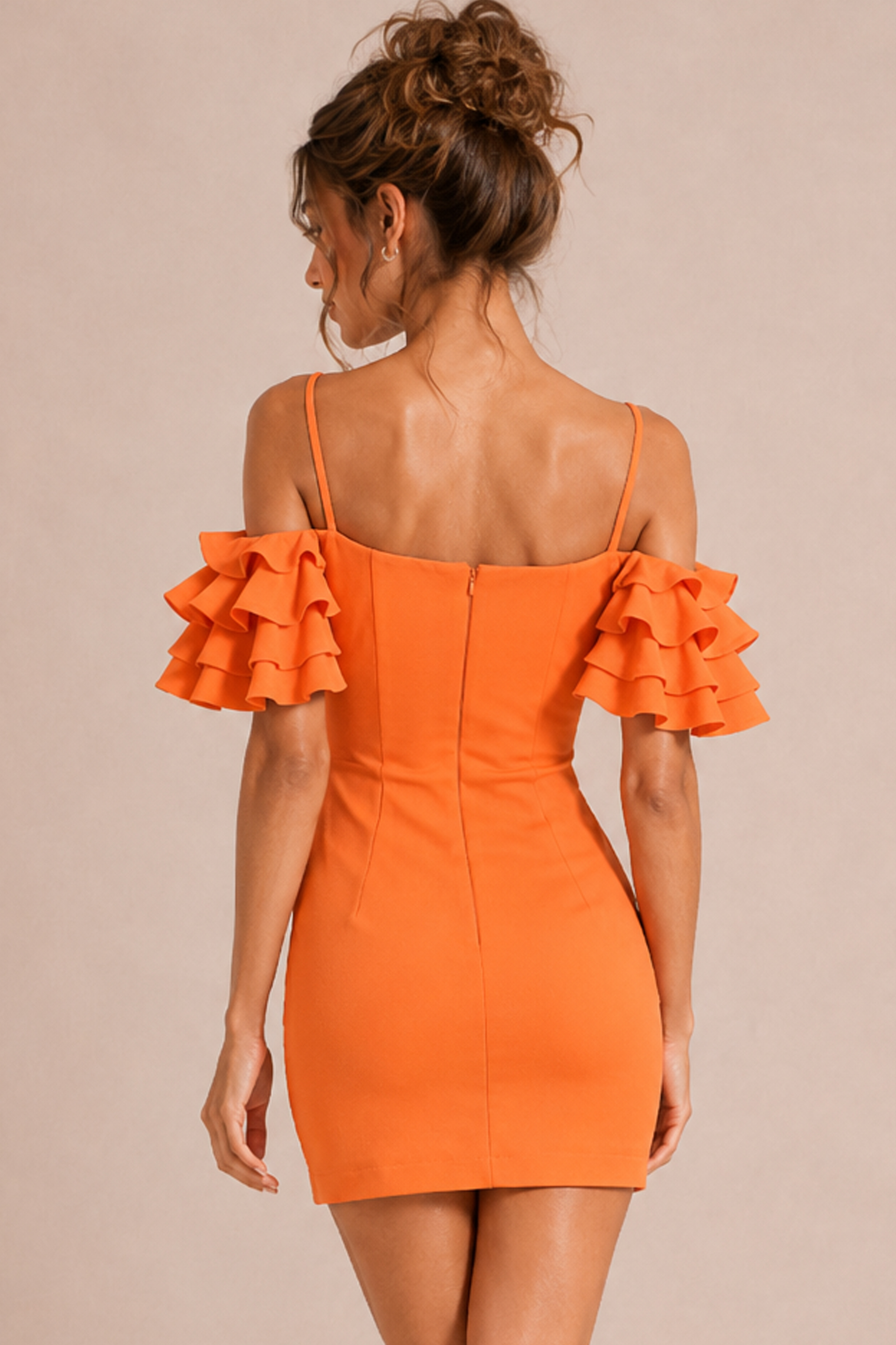 back view of orange fitted mini dress with tiered ruffle sleeve detail