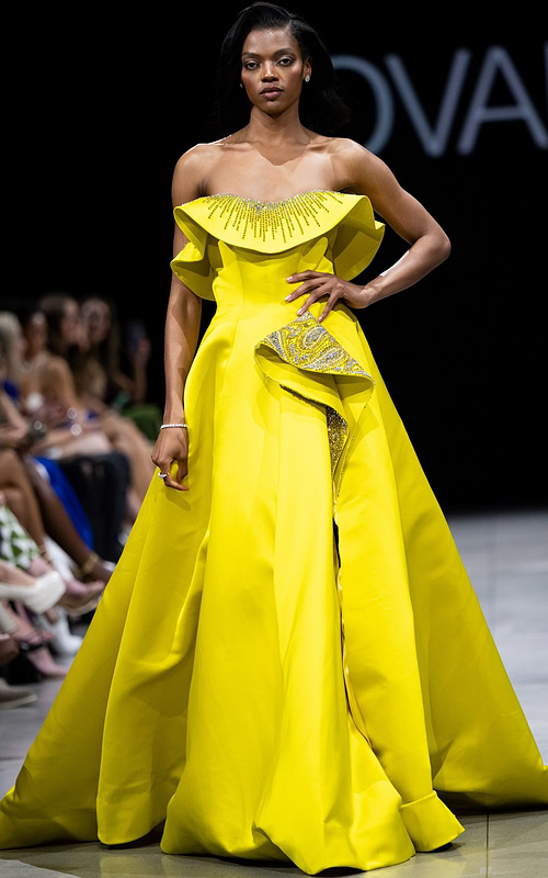 Model wearing Jovani S36369 yellow gown with off-the-shoulder neckline and beaded detail