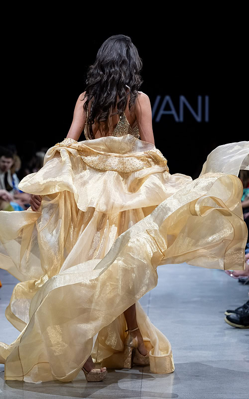 back view of Jovani S38445 gold dress with flowing skirt