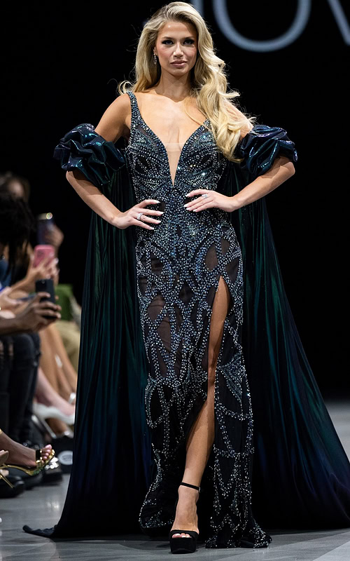 Model wearing Jovani S39121 black gown with a plunging neckline and high slit