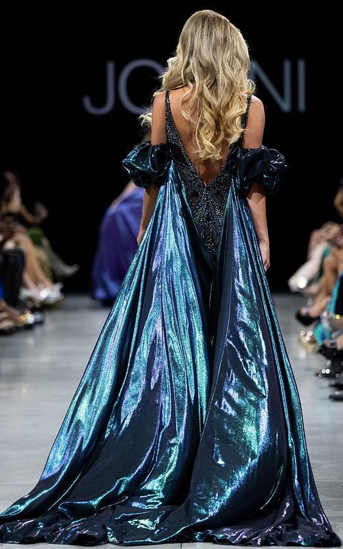 Back view of model wearing Jovani S39121 showcasing cape and beadwork