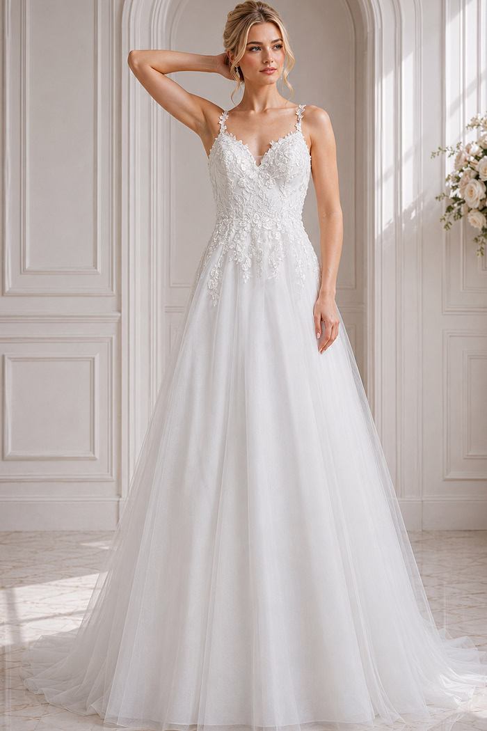 A-line tulle gown with floral lace appliqués and delicate straps.